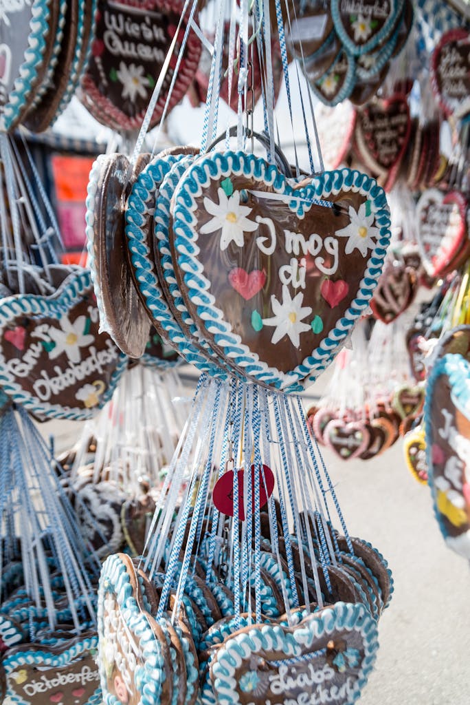 Close-up of heart-shaped gingerbread cookies at Munich's Oktoberfest, featuring traditional decorations.