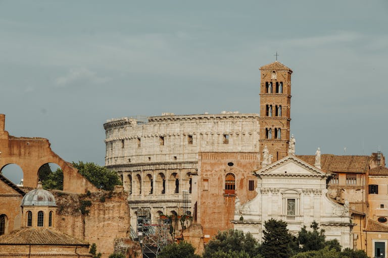 View of the iconic Colosseum and surrounding ancient Roman architecture in Rome, Italy.