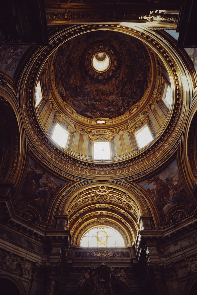 A stunning view of a frescoed dome inside a historic basilica in Rome, showcasing magnificent architecture.