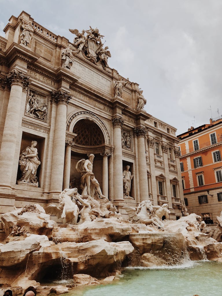 Capture the magnificence of the Trevi Fountain in Rome, showcasing intricate baroque architecture and sculptures.