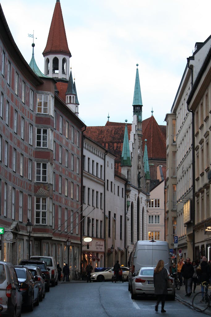 Explore Munich's historical architecture in this charming street scene featuring Old Town Hall.