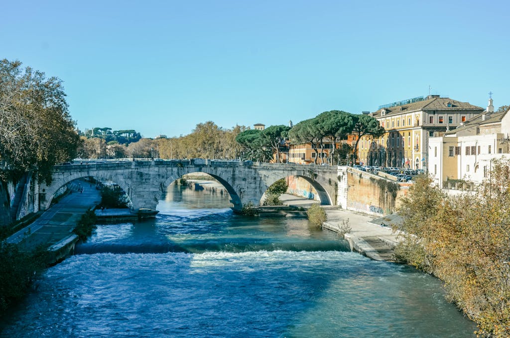 Picturesque view of Ponte Sisto spanning the Tiber River in Rome, Italy, on a sunny day.