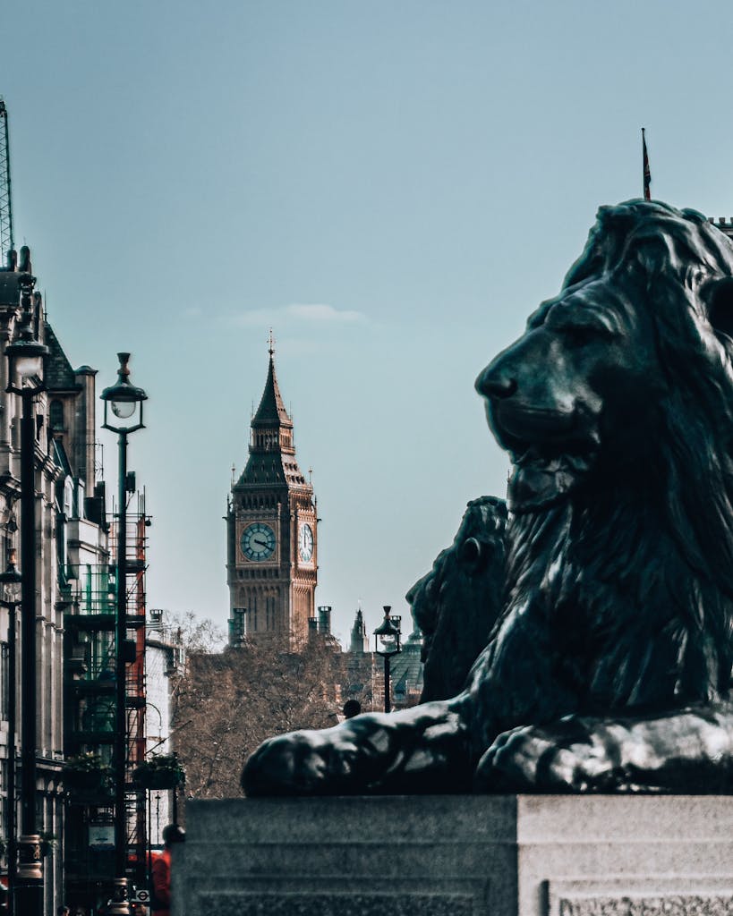 View of Big Ben and lion statue in Trafalgar Square, London, capturing iconic landmarks on a sunny day.